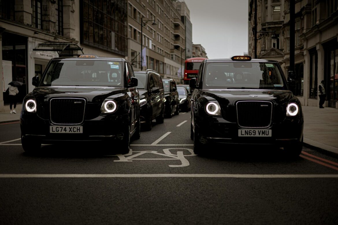 modern black taxis on london street