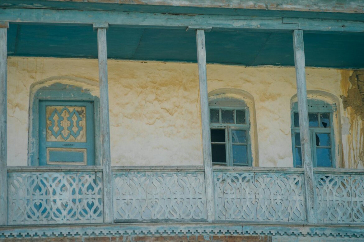brown concrete building with blue framed glass windows
