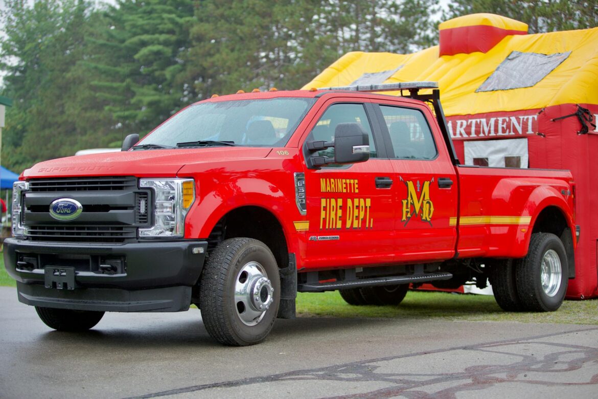 red pickup truck parked on the road