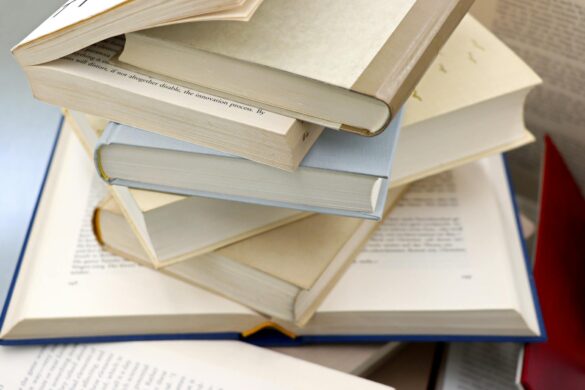 pile of academic and literary books in disorderly stack