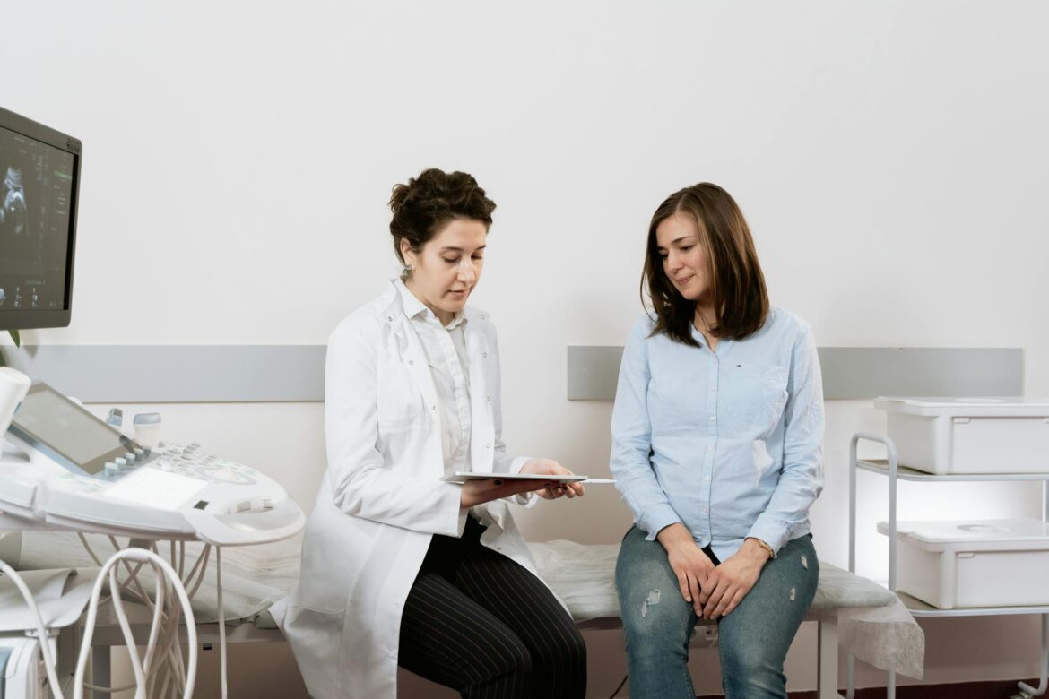 photo of pregnant woman having a consultation