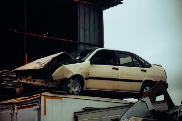 crashed car on metal scrap heap outdoors