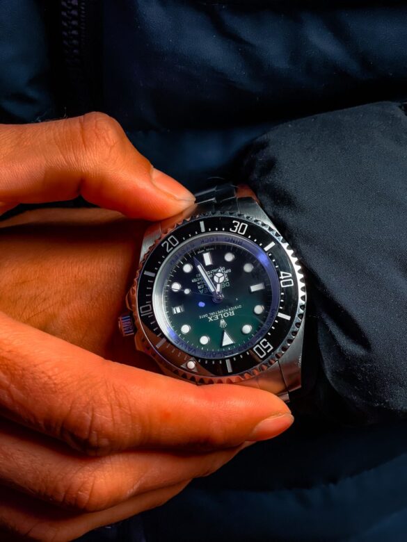 holding a rolex watch