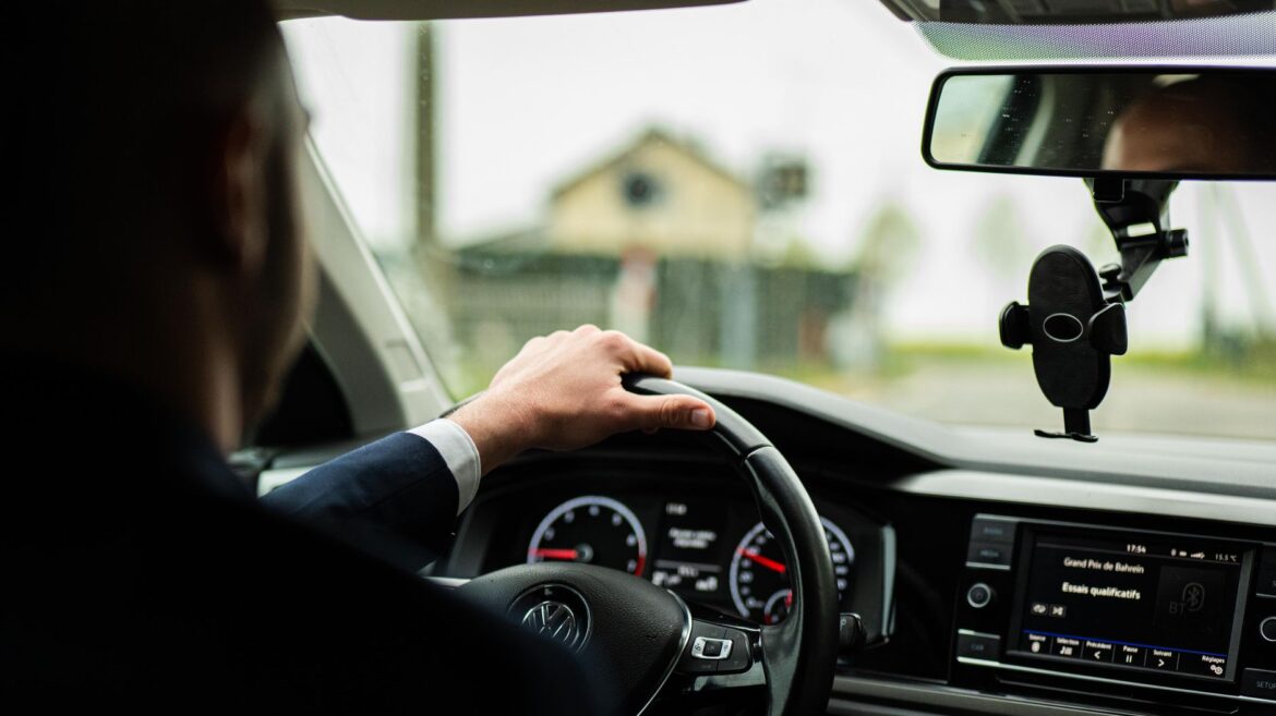 businessman driving car on rainy day