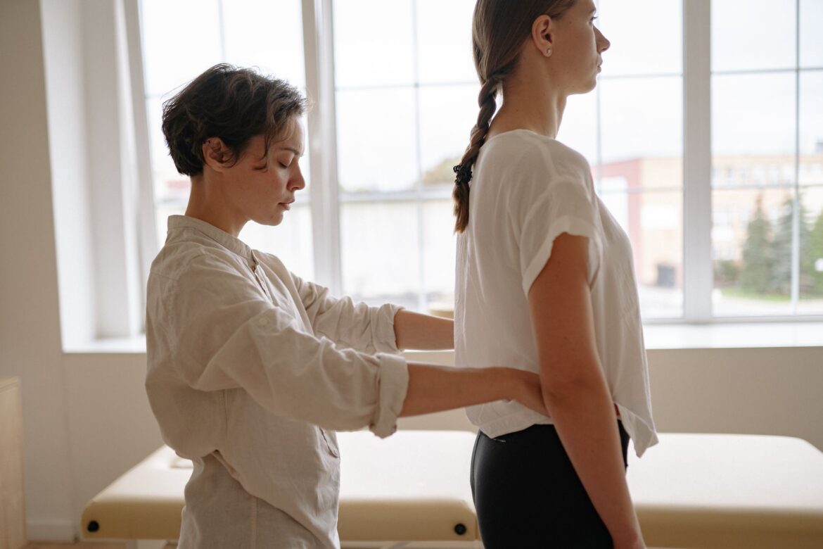woman in white long sleeve shirt holding woman s waist