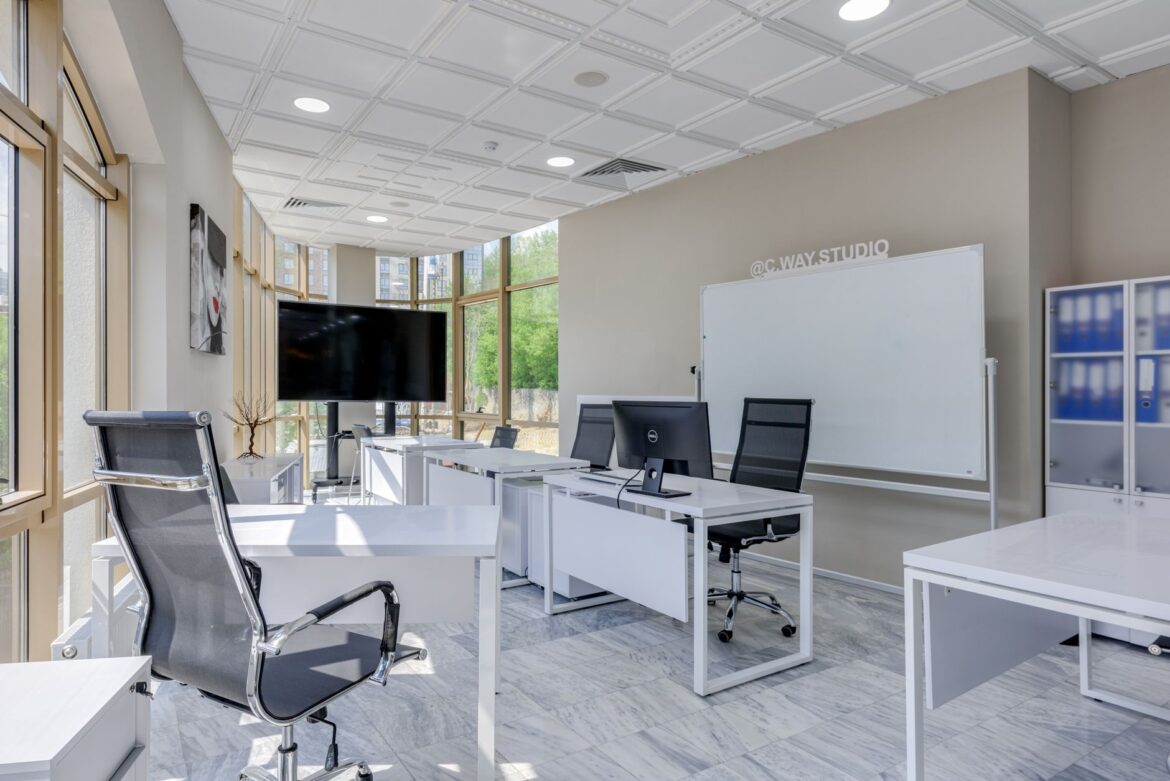 white desks and swivel chairs in the office